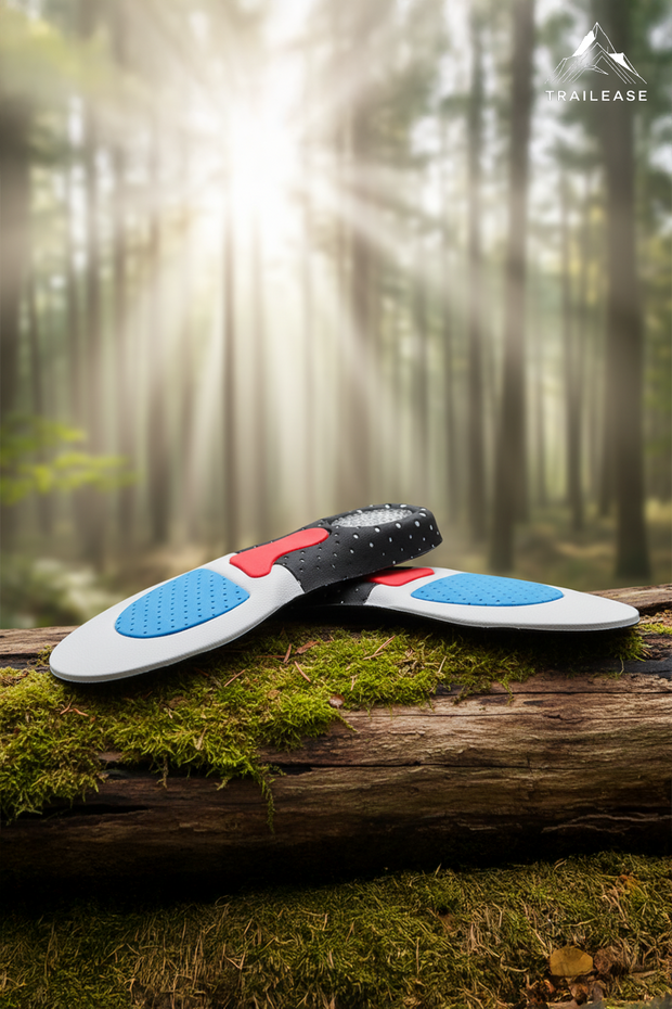 TrailEase Stability Hiking Insoles Two black and white shoe insoles with red and blue accents on a log in a forest setting, featuring the TrailEase brand